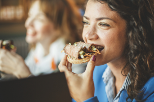 young lady eating sandwich Destination Properties