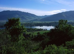 This is a beautiful picture in Ogden Valley with the Pineview Reservoir winding through the middle. The lush green landscape is inviting and shows the majestic beauty of the Ogden Valley and of Utah.