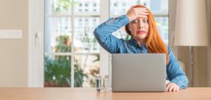 Woman using computer stressed